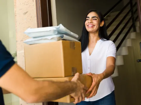 Woman receiving some boxes and packages at her deliverable address